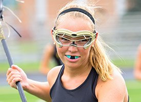 Female lacrosse player with mouthguard